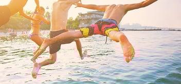 two men jumping into the ocean
